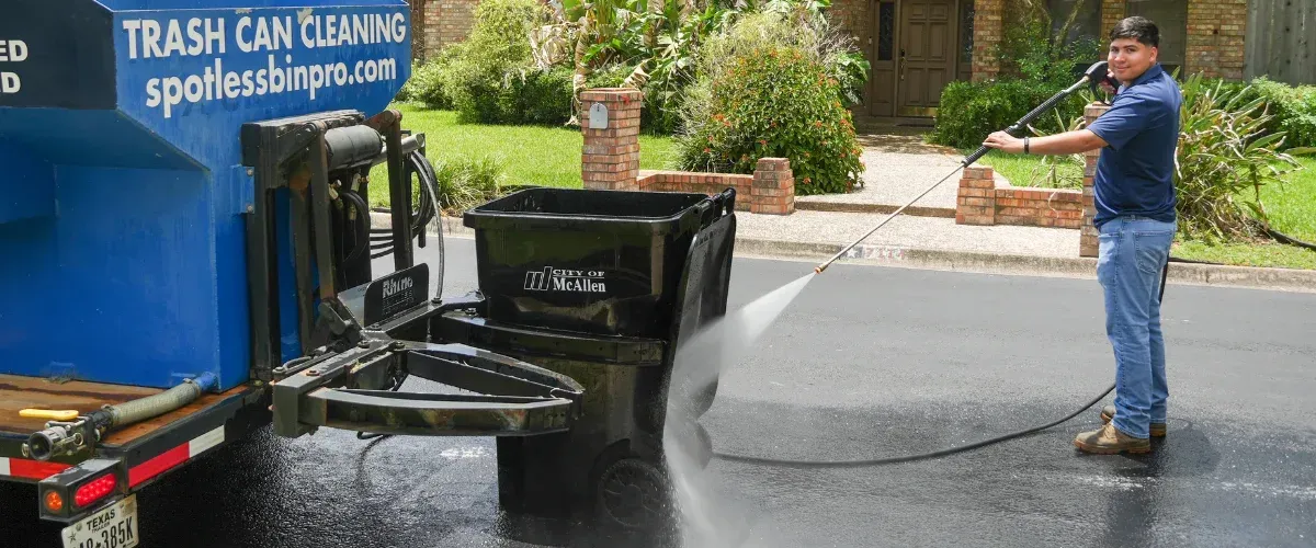 Trash bin cleaning service washing residential garbage bin with professional equipment