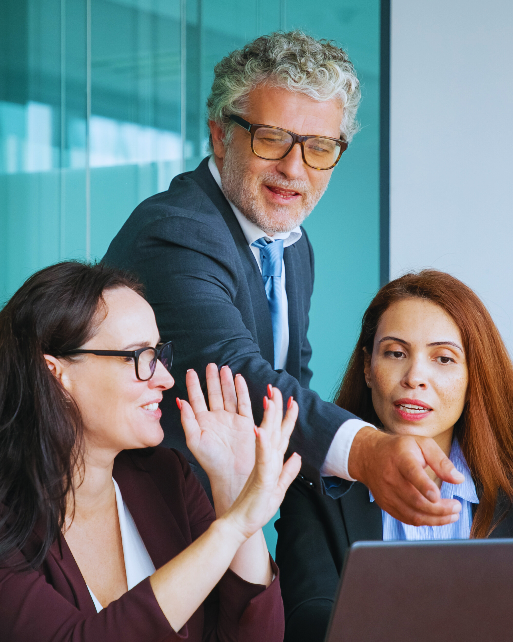 Business consulting professionals collaborating and discussing strategy in a modern office environment