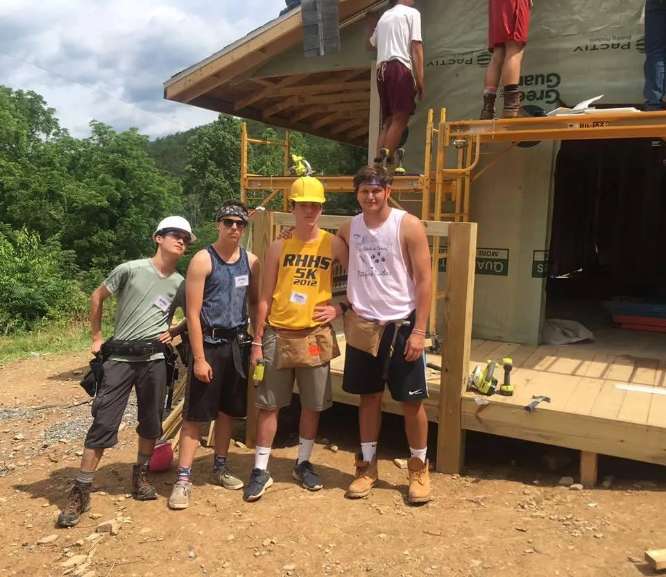 Fuller Center partners and volunteers standing together at a home repair project.