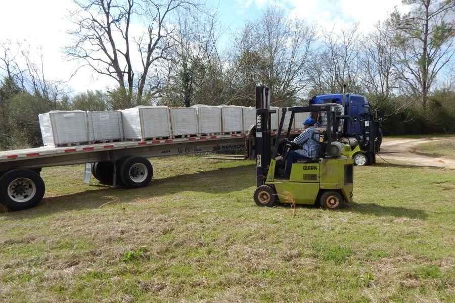Forklift delivering insulation panels to a job site