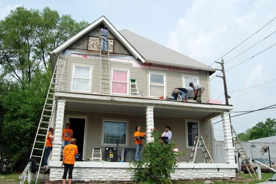 Group of volunteers fixing many aspect of unsafe house