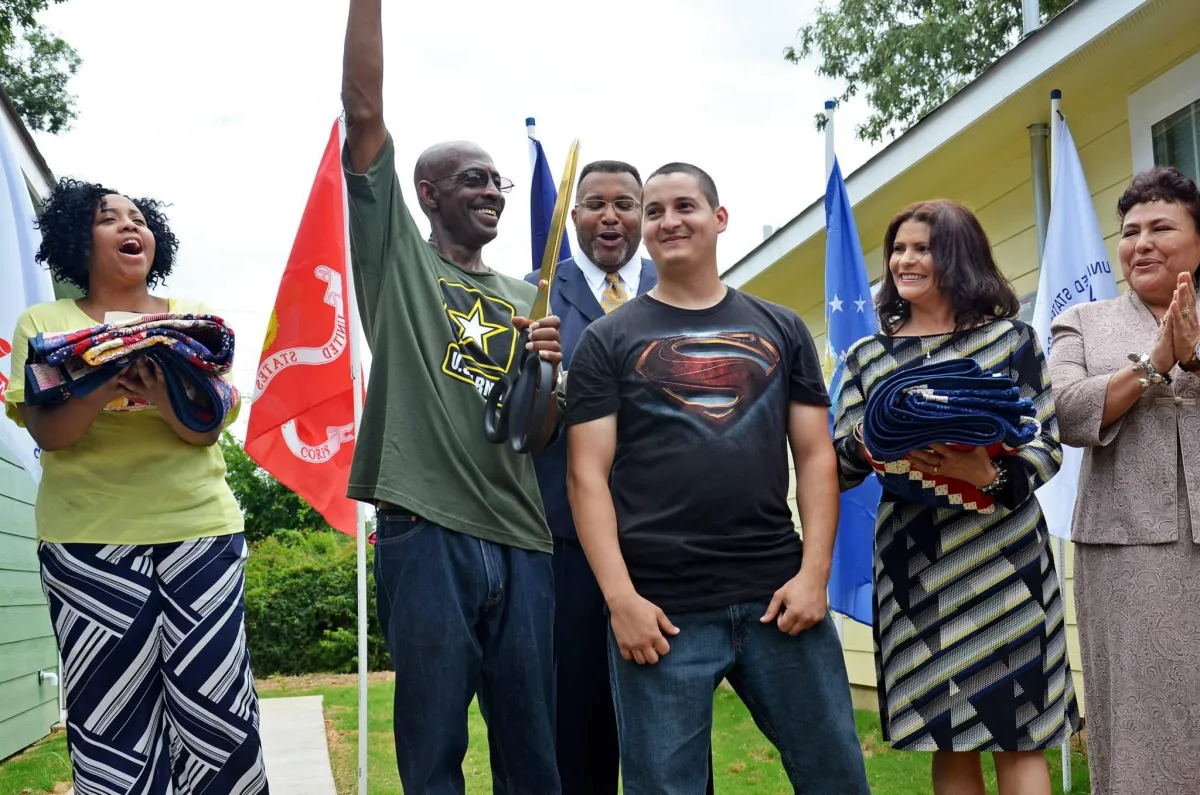 happy Army Veteran and neighbors with flag