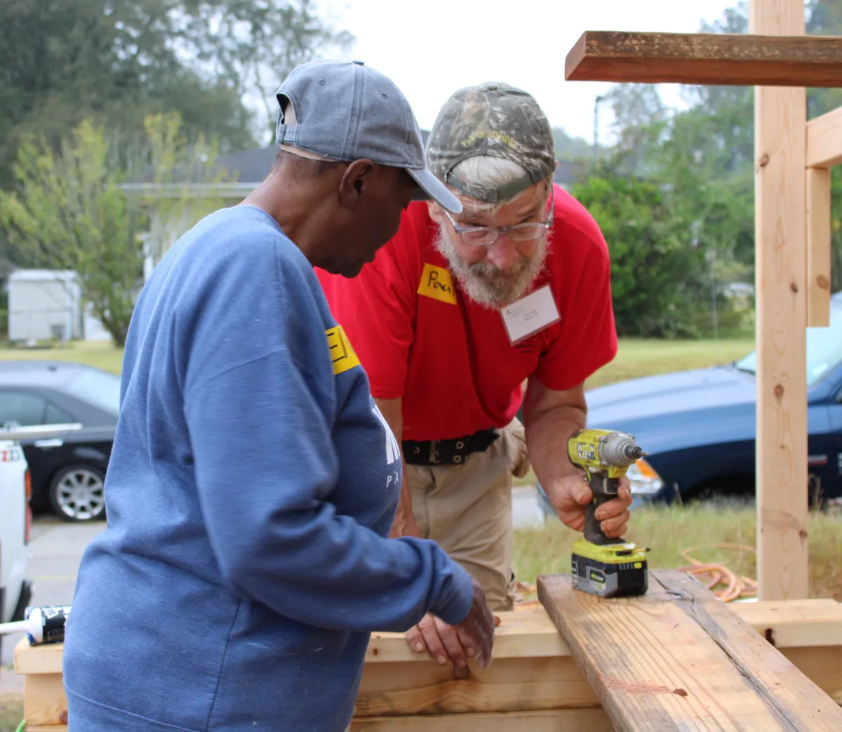 homeowner and volunteer preparing lumber for ramp