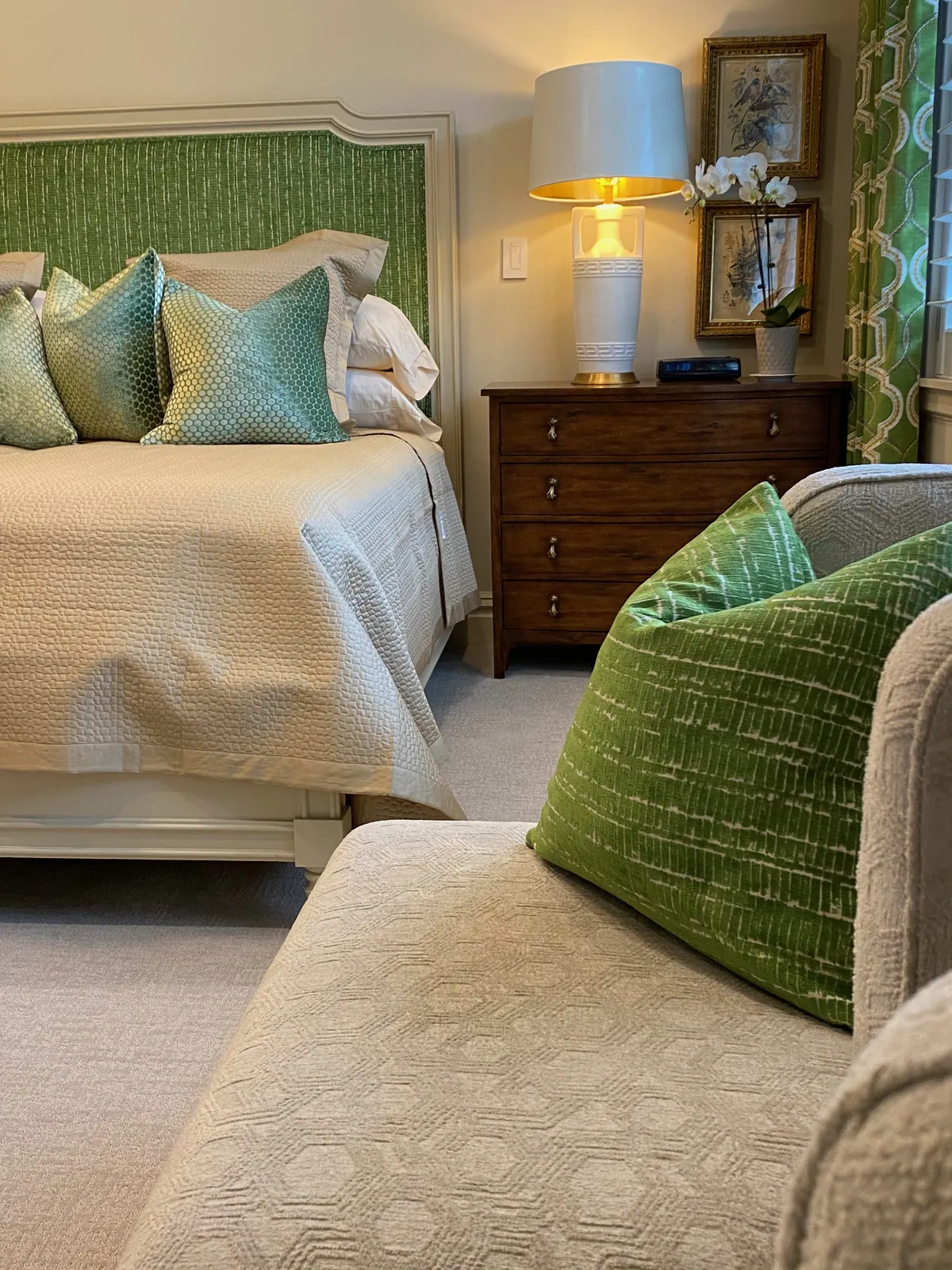 Bedroom with green velvet headboard and teal pillows