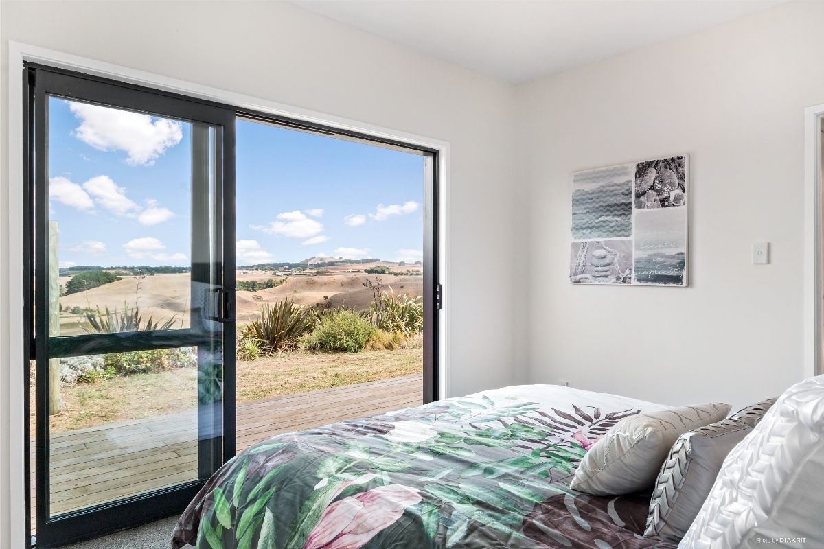 small bedroom design with large window and natural light compact home