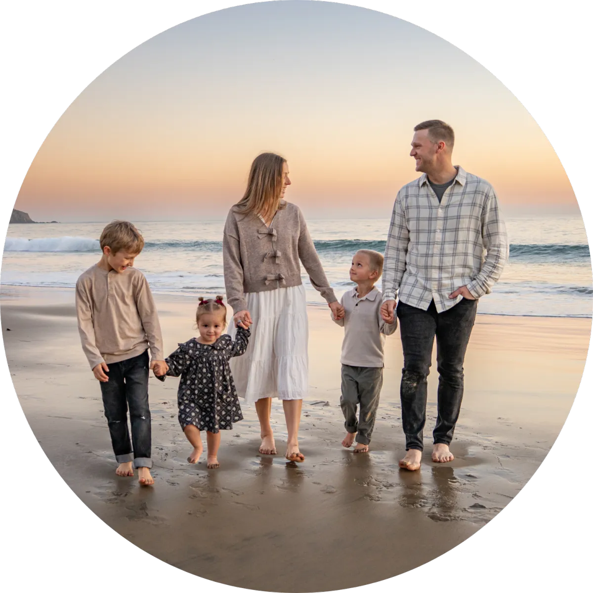 Thomas Nilsen walking barefoot on the beach at sunset with his wife and three children, representing faith, family, fatherhood, and intentional living on the It’s Thomas Nilsen website.