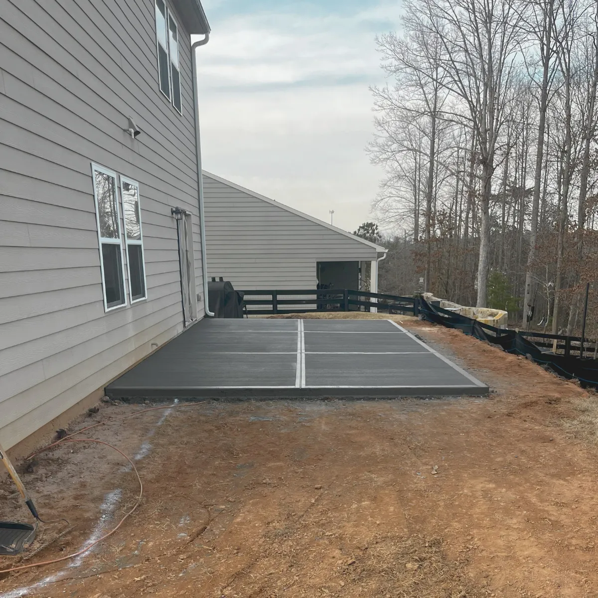 Concrete patio installation with broom finish – North Georgia residential project by Askew & Sons