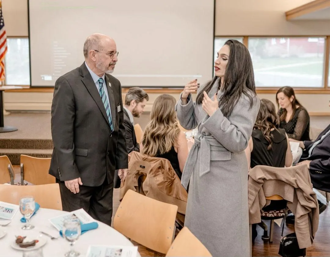 Rosa signing with Mr. Bert Carter, President/CEO of the Willie Ross School for the Deaf