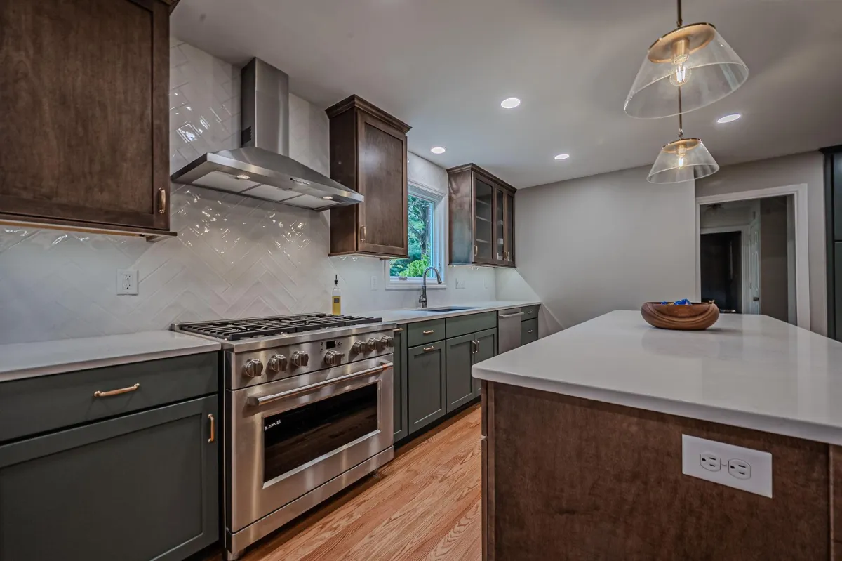 a large kitchen with a marble island and white cabinets