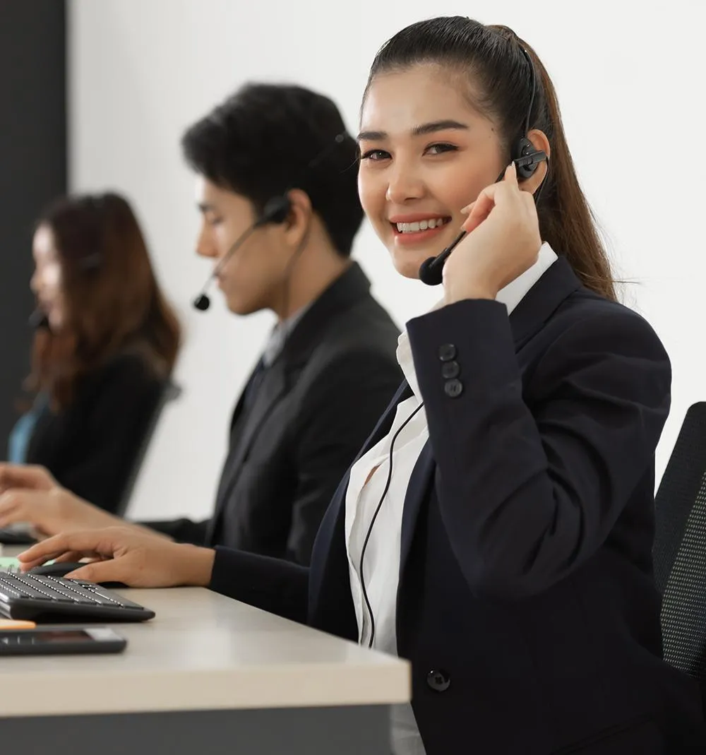 A woman wearing a headset, engaged in conversation, with a focused expression on her face