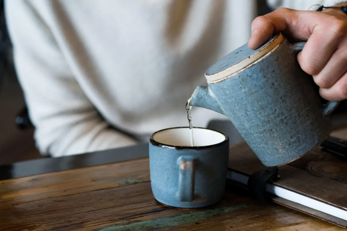 pouring water into a cup