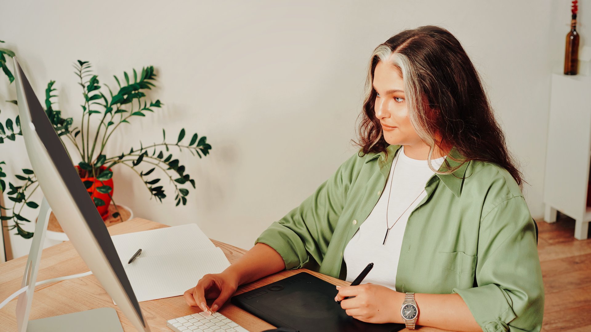 Course creator working at her desk, moving her online course to a new platform without having to rebuild it.