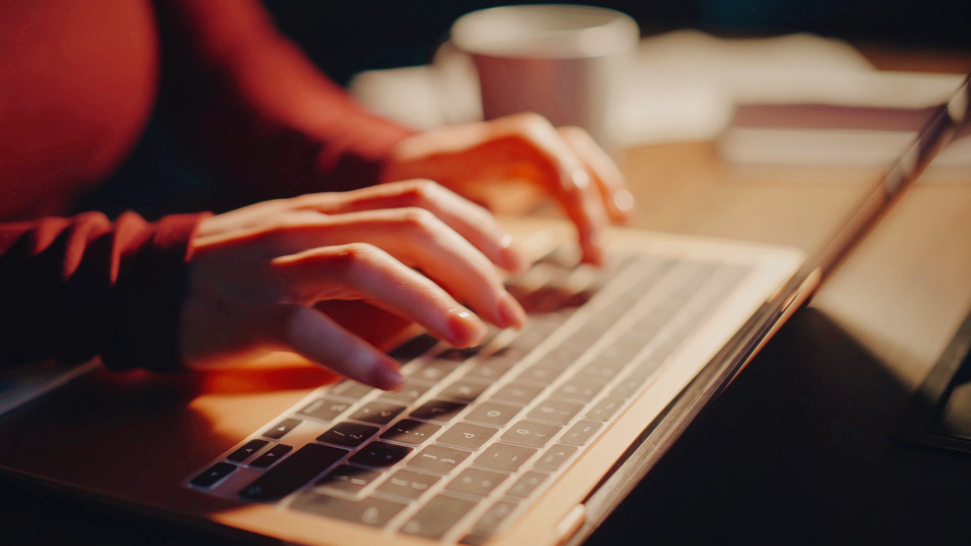 Close-up of hands typing at a laptop late in the evening, weighing whether to finally switch from WordPress to an all-in-one platform.