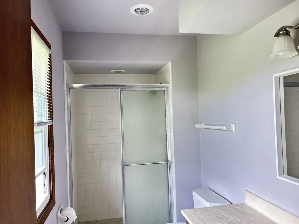 Spacious modern living room in Milwaukee with beige walls, stylish furniture, and natural light accentuating detail.