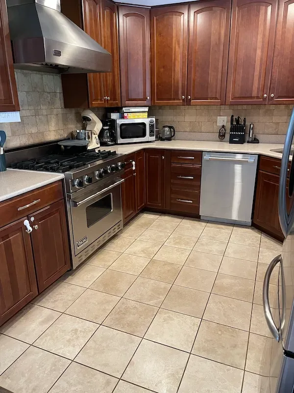 Deep cleaned kitchen with polished countertops, sanitized appliances.