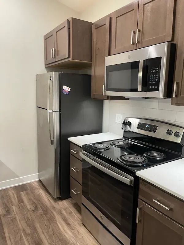 Regular kitchen maintenance cleaning keeping appliances, cabinets, and floors spotless.