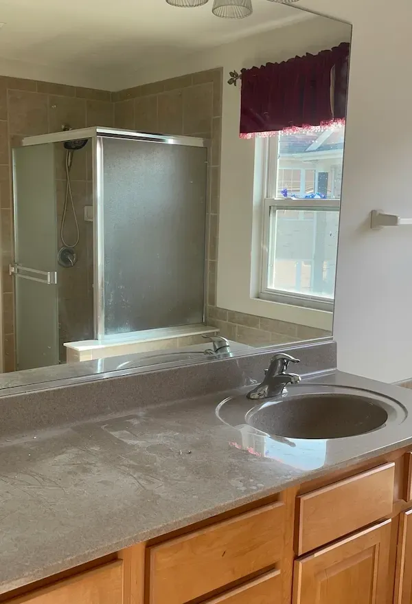 Bathroom covered in post-construction dust and debris before professional cleaning by Rux Cleaning.