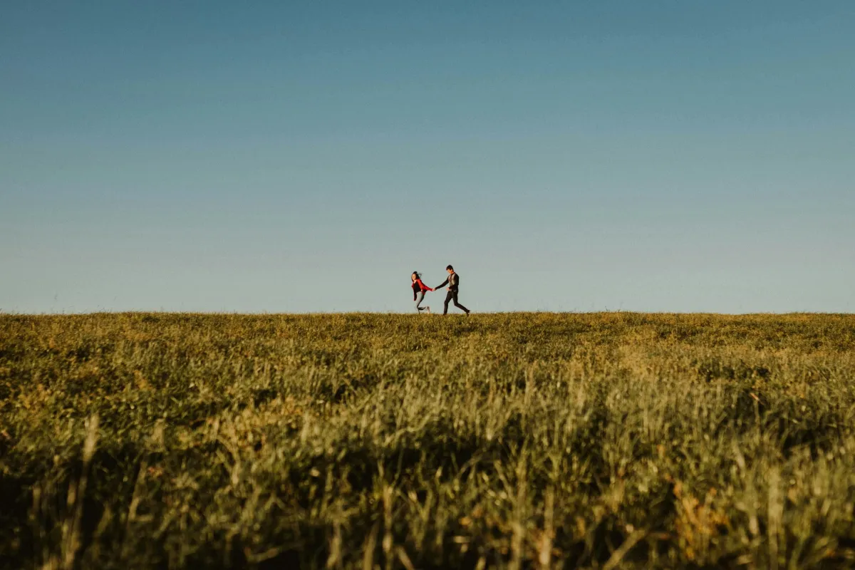Couple running happily in field