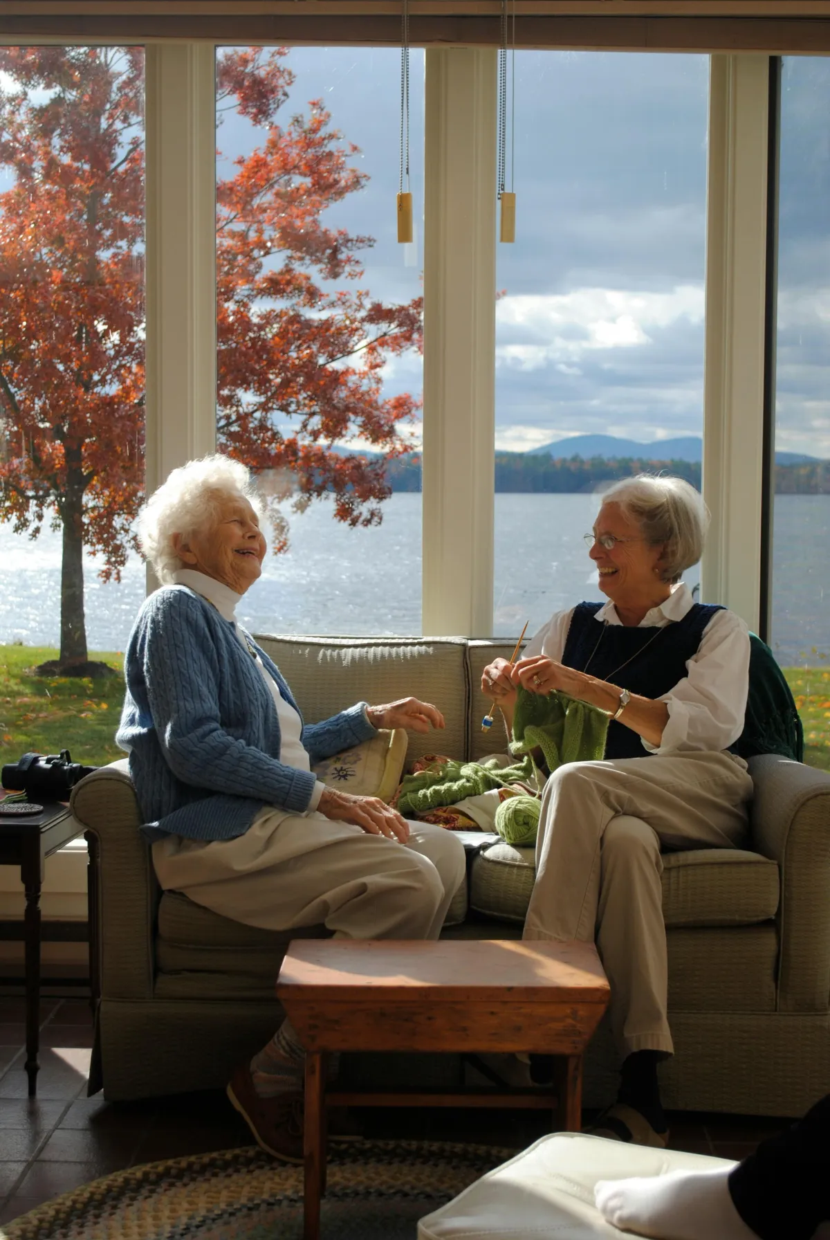 Elderly Women Sitting on Sofa While Having a Conversation