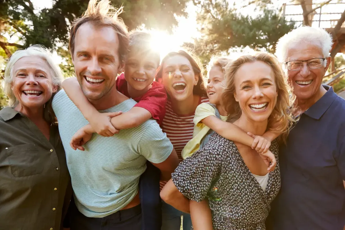 Multi-generational family smiling together, symbolizing the long-term financial security and legacy protection provided by Legacy Insurance and Financial Services.