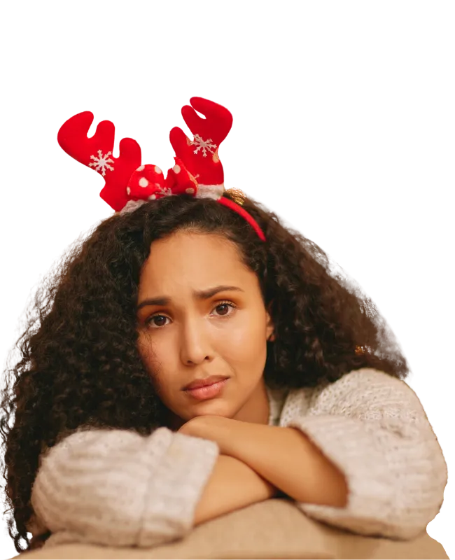 a woman wearing a christmas headband with a troubled look on her face