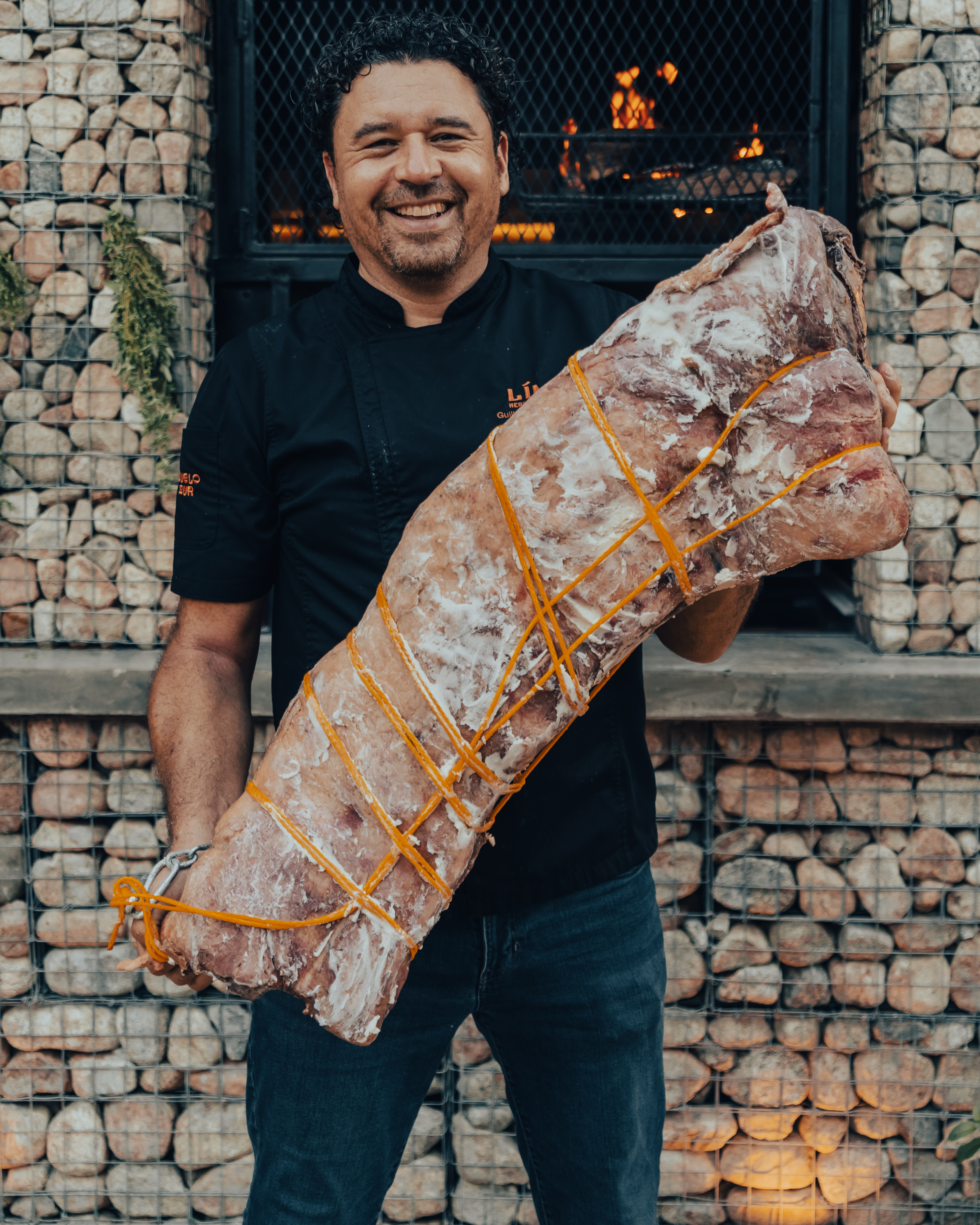 Chef Guillermo J. Gómez at the fire