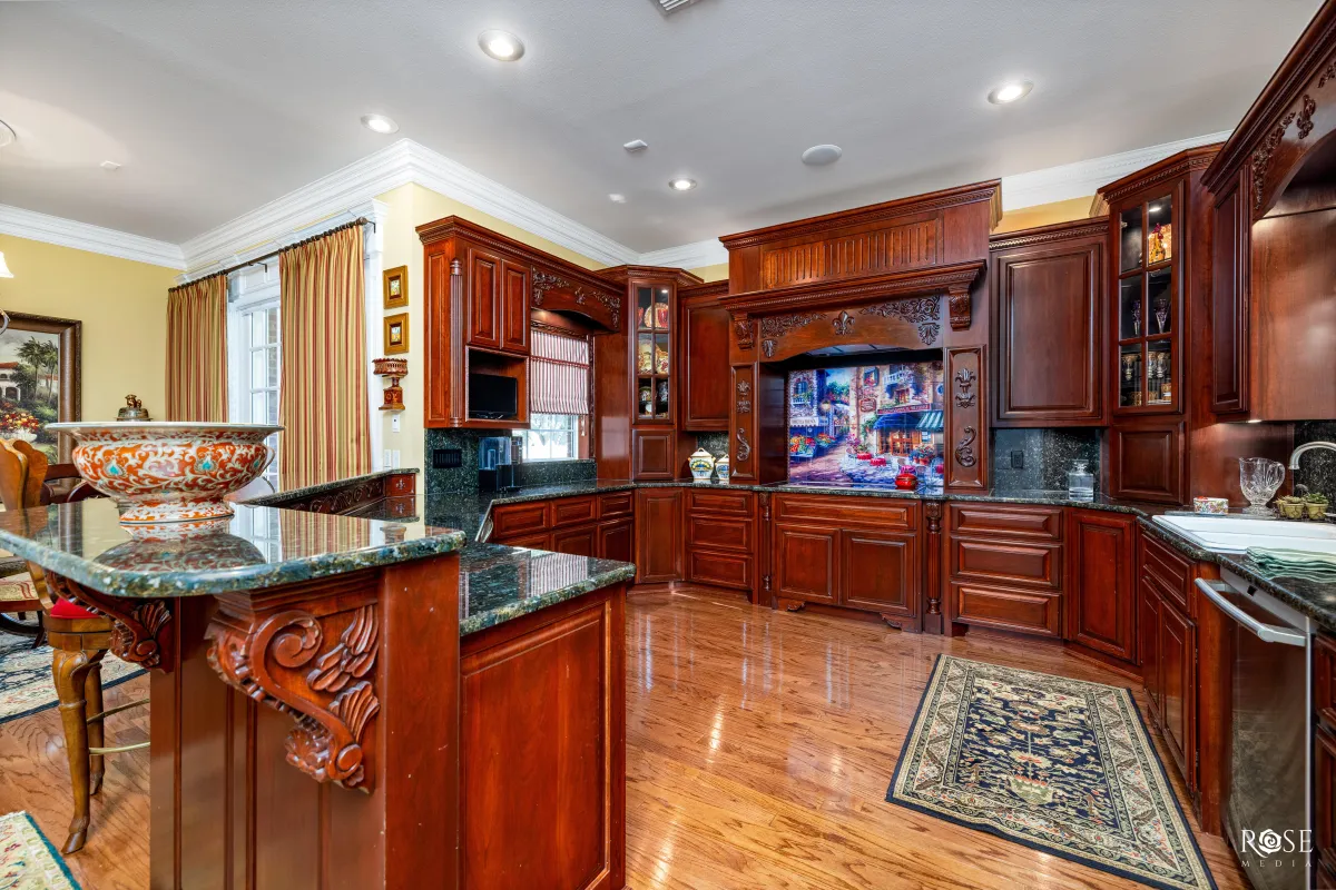 luxury custom kitchen with granite countertops and electrolux appliances, hardwood floors and custom cabinetry