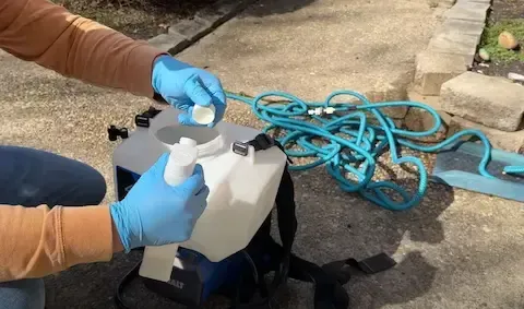 Preparing outdoor pest-control treatment mix for Beloit Pest Control service.