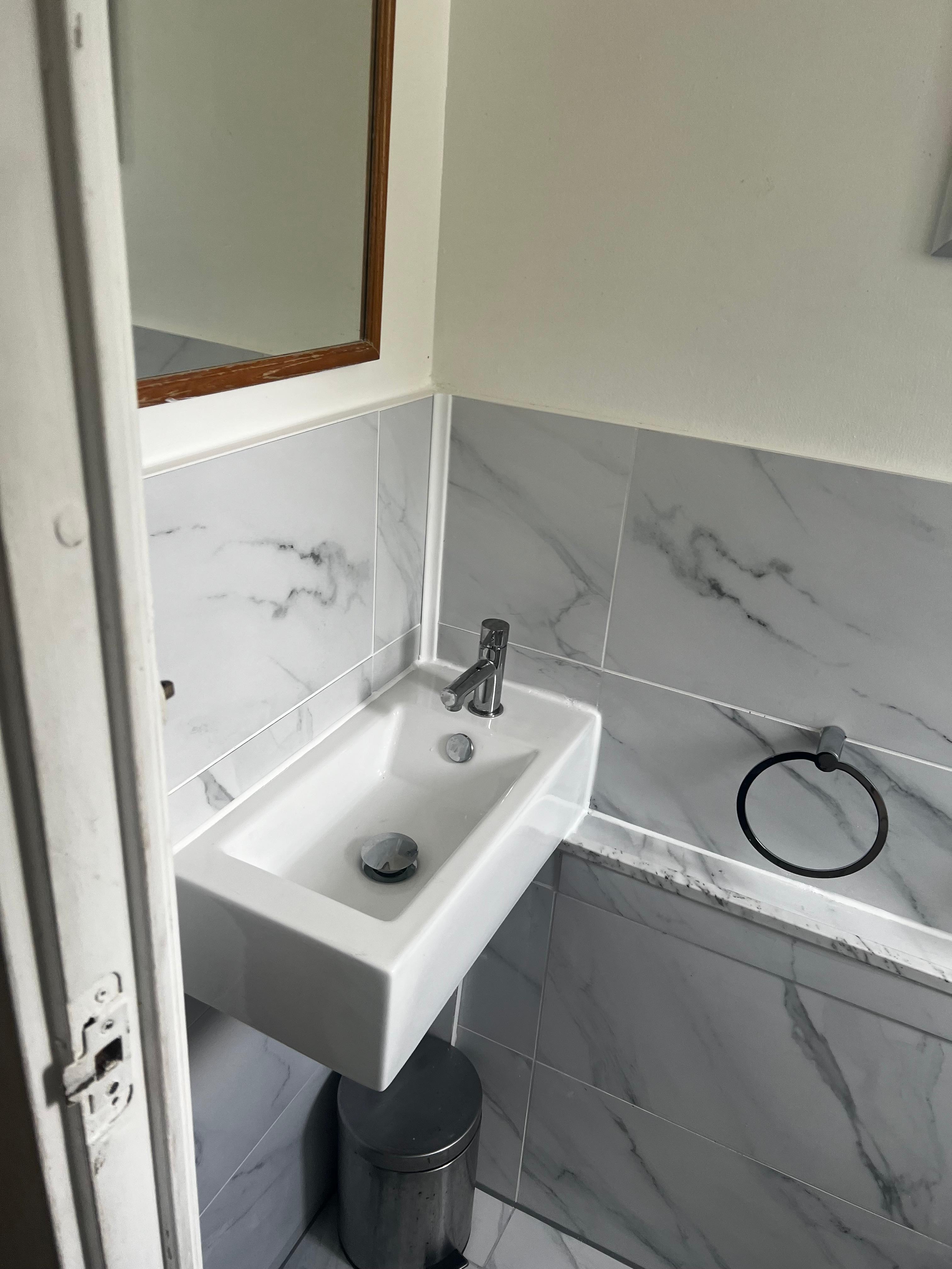 Modern bathroom sink and tap plumbing installation completed to a high standard.