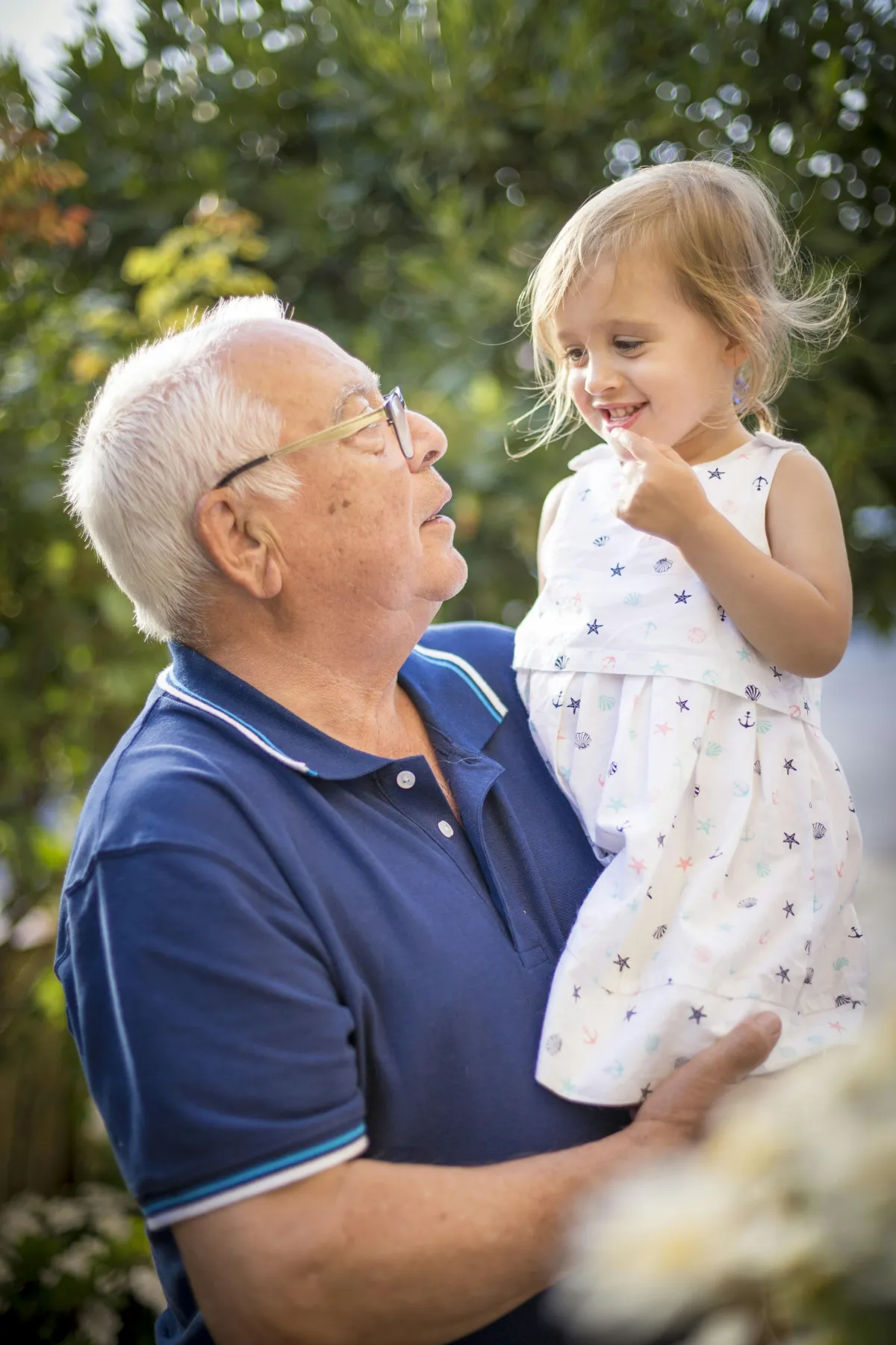 A grandfather sharing a happy moment with a young child