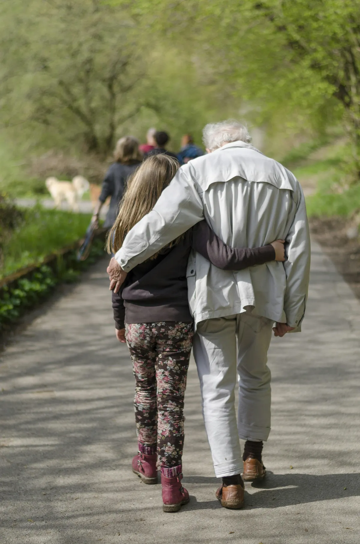 An older couple walking together outdoors