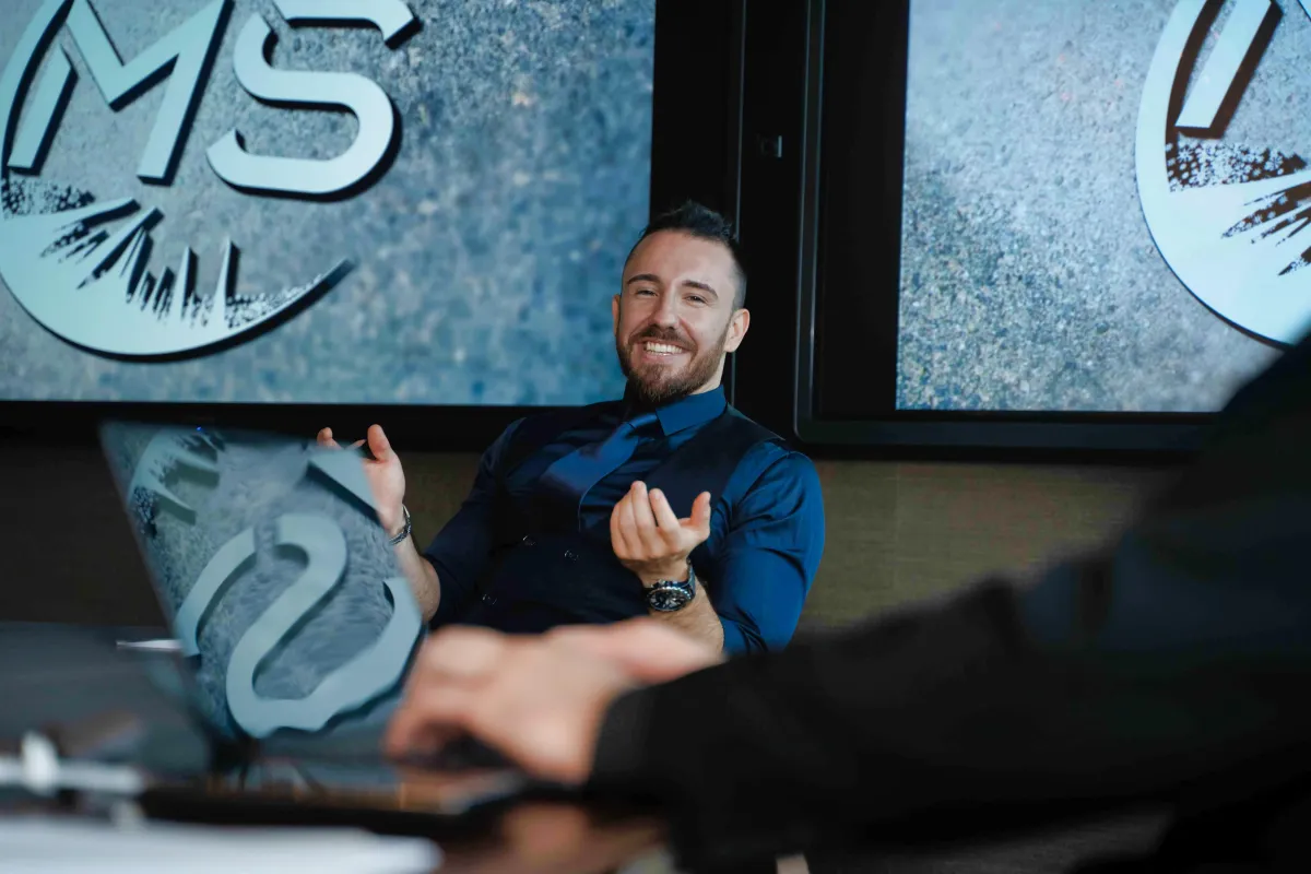 an aerial view of a city square with blue and white umbrellas