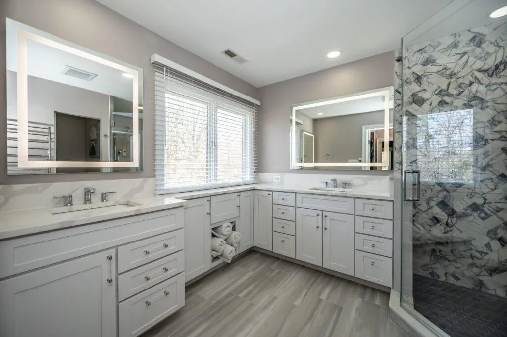 newly renovated bathroom, white drawers nd glass door
