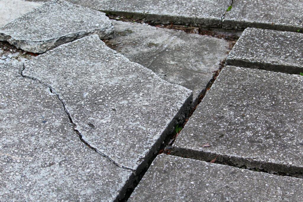 Uneven, cracked paving creating a trip hazard