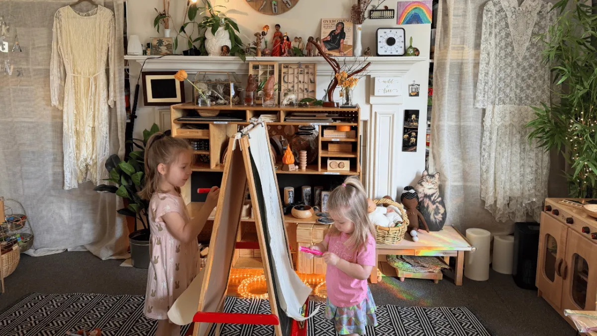 children making art on easel in home childcare