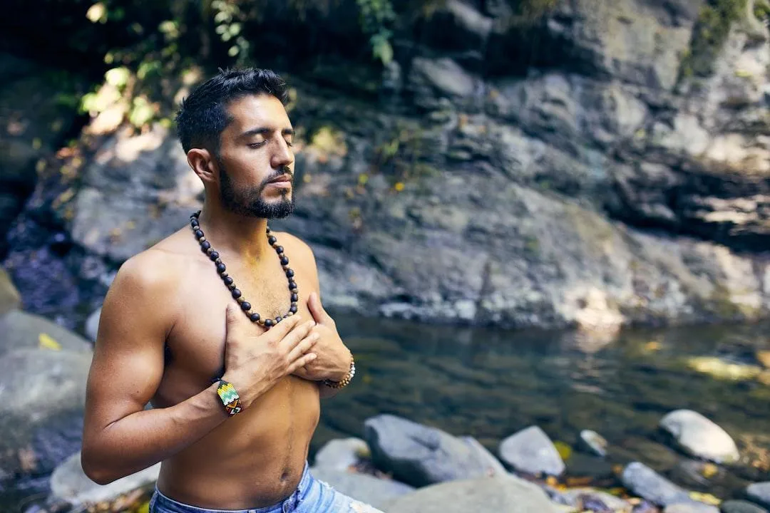 meditating man holding heart