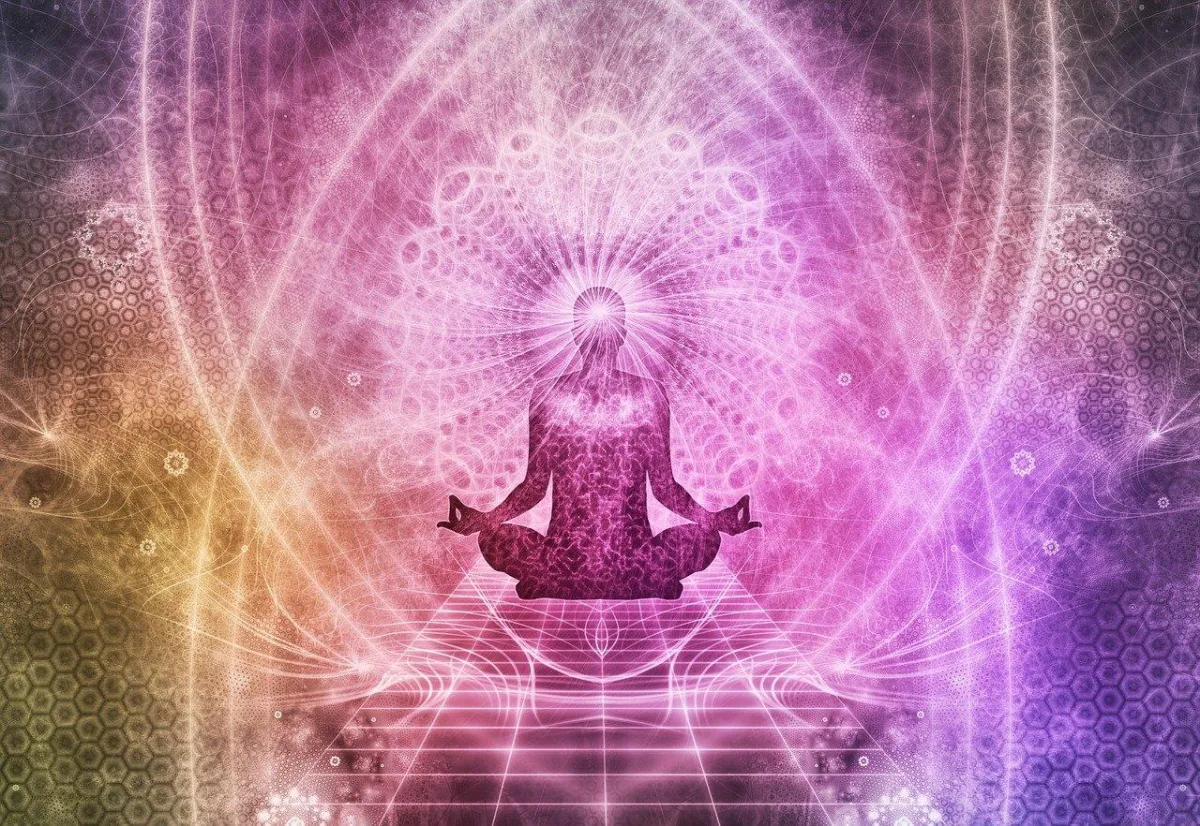 meditating figure with radiant sacred geometry
