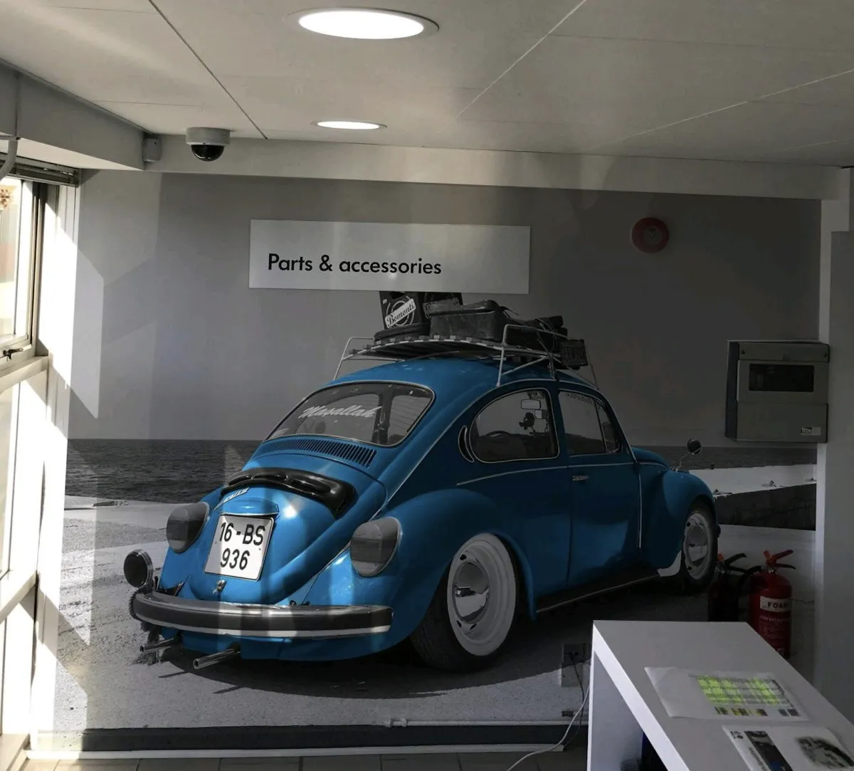 Large office wall covered with a blue VW Beetle car.