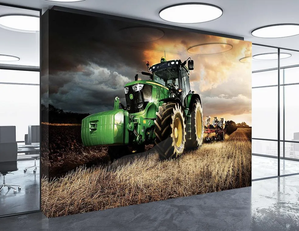 A large display of an office wall with a green tractor printed on it.