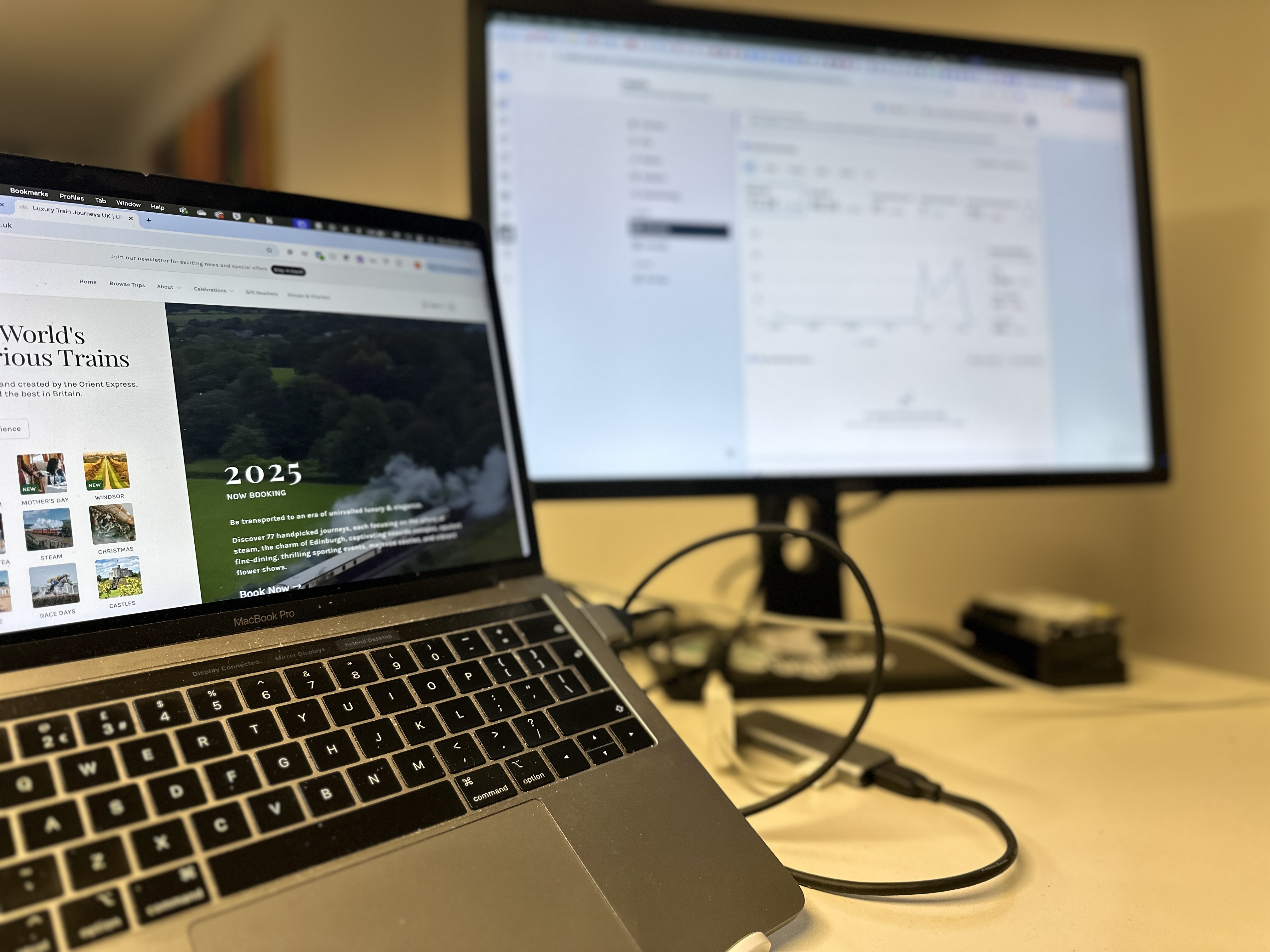 Laptop and computer monitor with a steamtrain and social media results on the screens.