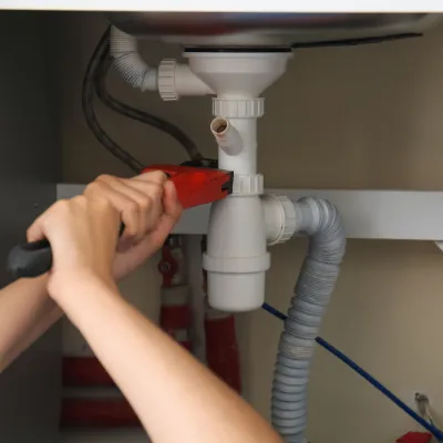 Personal Plumbing Homecare engineer fixing a leak in a High Wycombe kitchen
