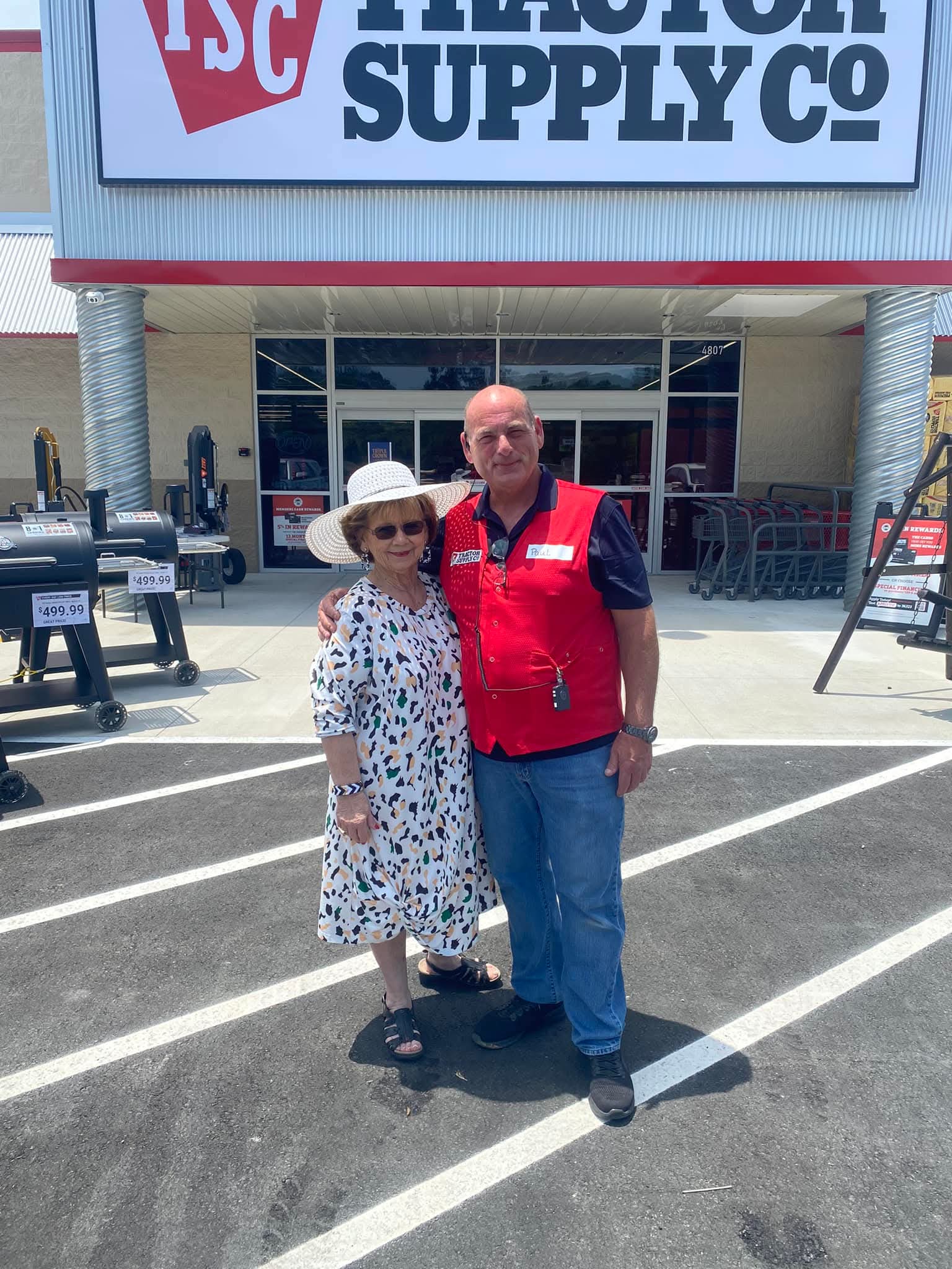 Elderly man in traditional attire with a crowd