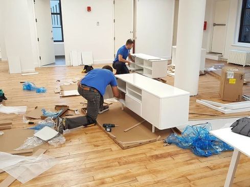 A speeding train with blue stripes moves quickly.