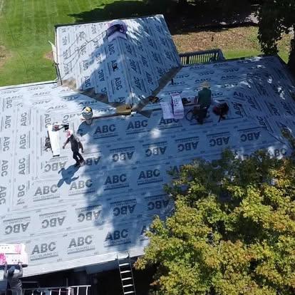 Riverside Restoration contractor inspecting a residential roof in Edwardsville, IL, providing repair services.