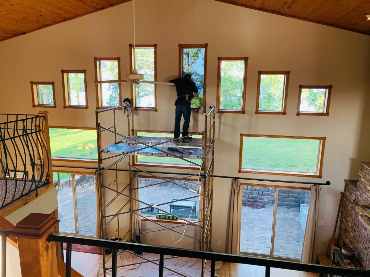 Residential window film install on scaffold for heat and glare reduction