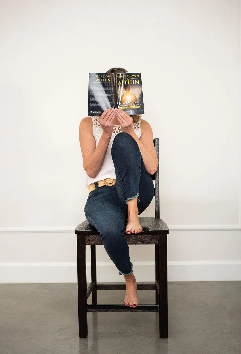 Kerrie proudly holding her bestselling book, a testament to her expertise and impactful contributions.