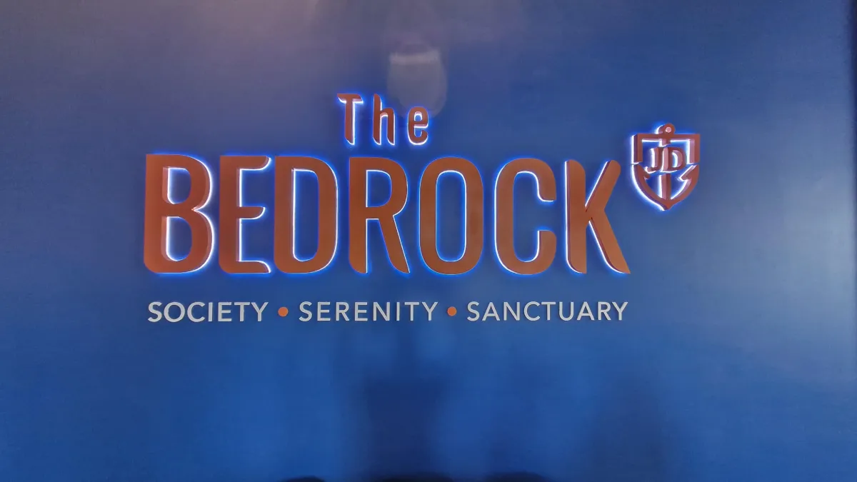 The Bedrock brand wall featuring logo and tagline at Jesselton Docklands sales gallery.