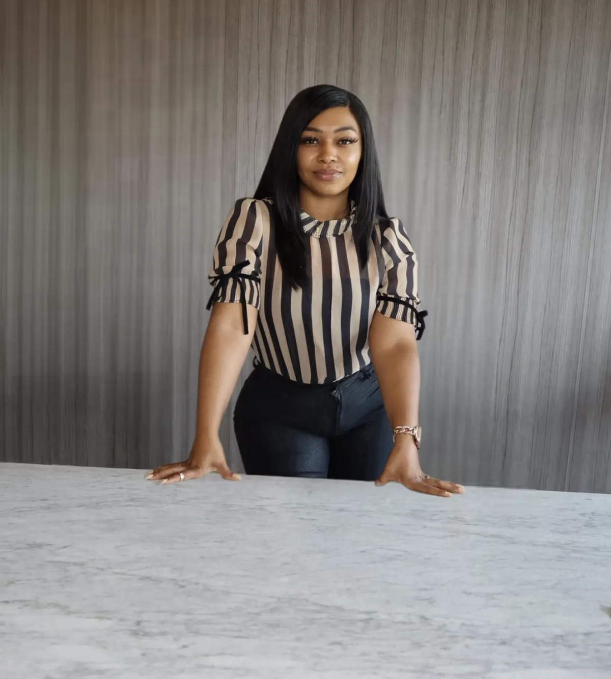 A round, pleated handbag with a dark plaid pattern.