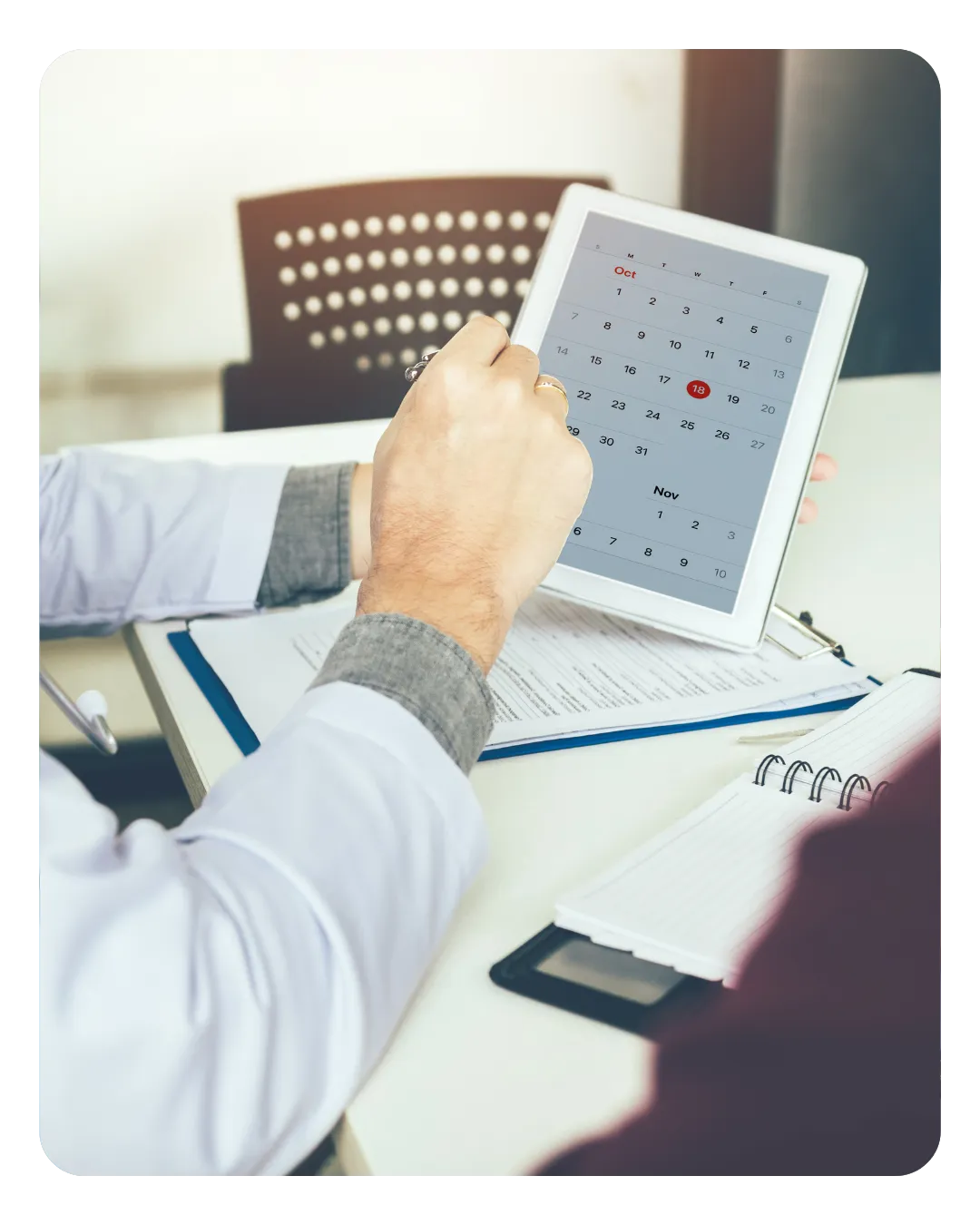 Holding a tablet that has a calendar on it