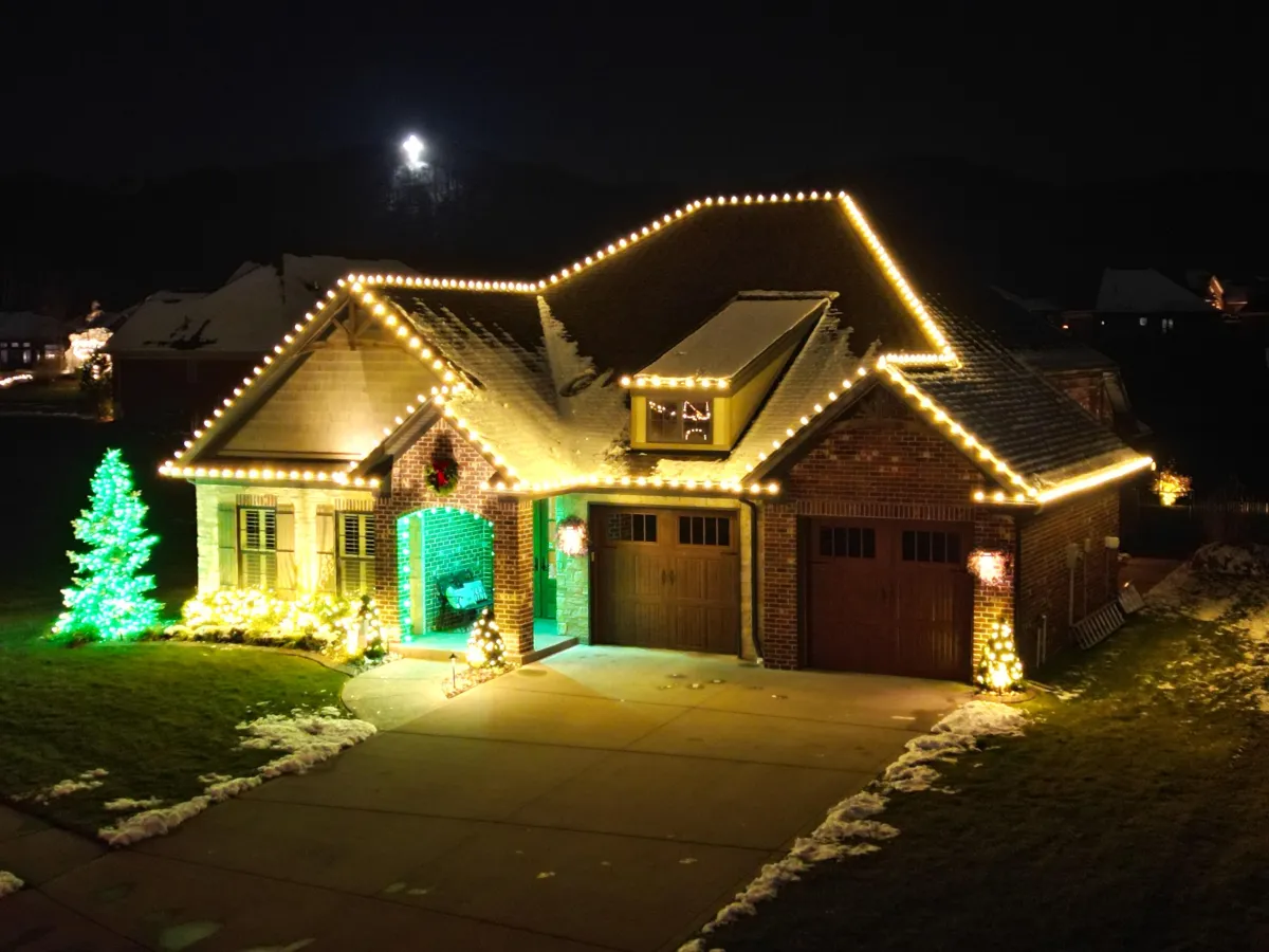 Home decorated with professional Christmas lights at night